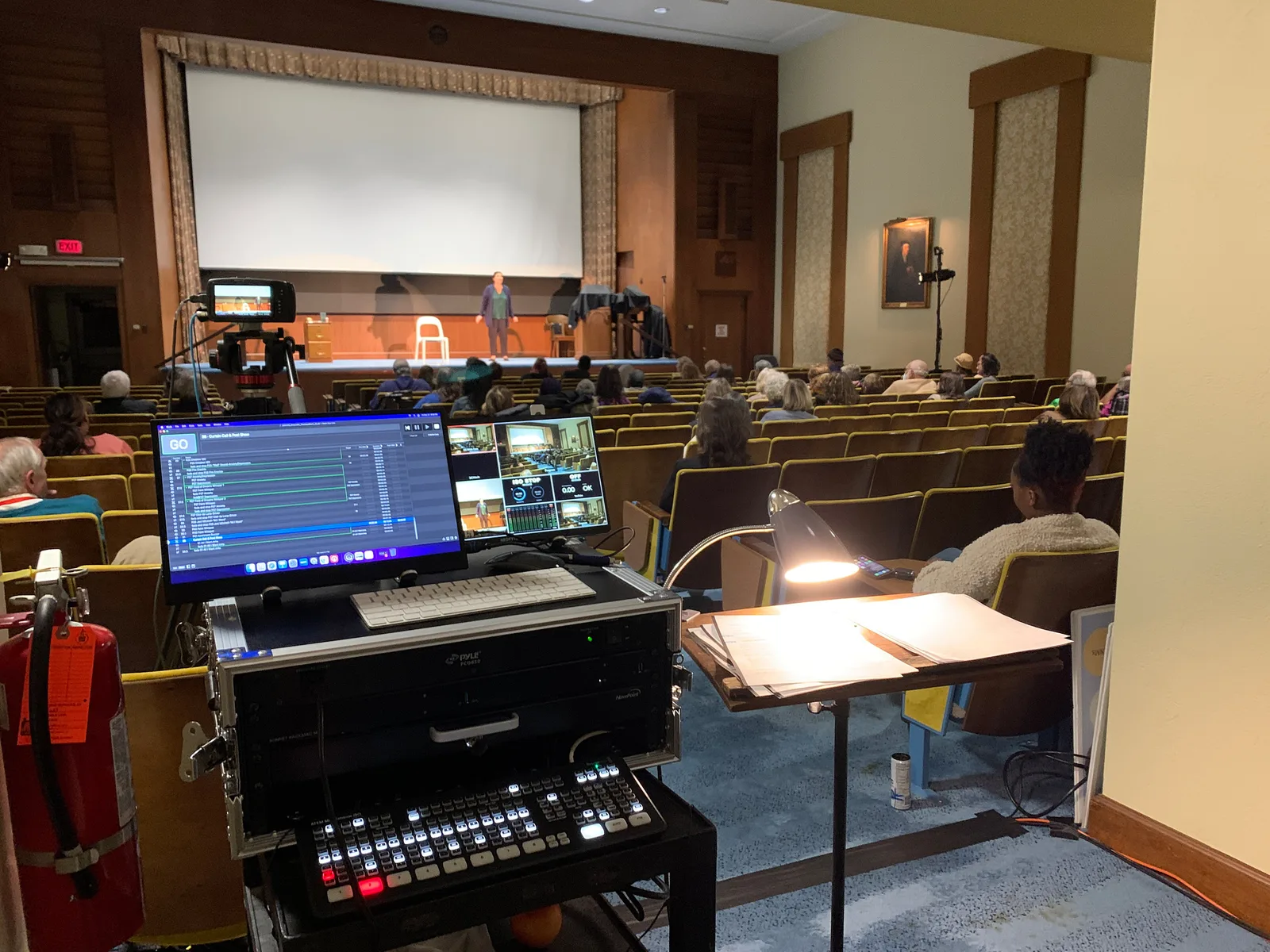Auditorium livestream — production station with video switcher and camera
